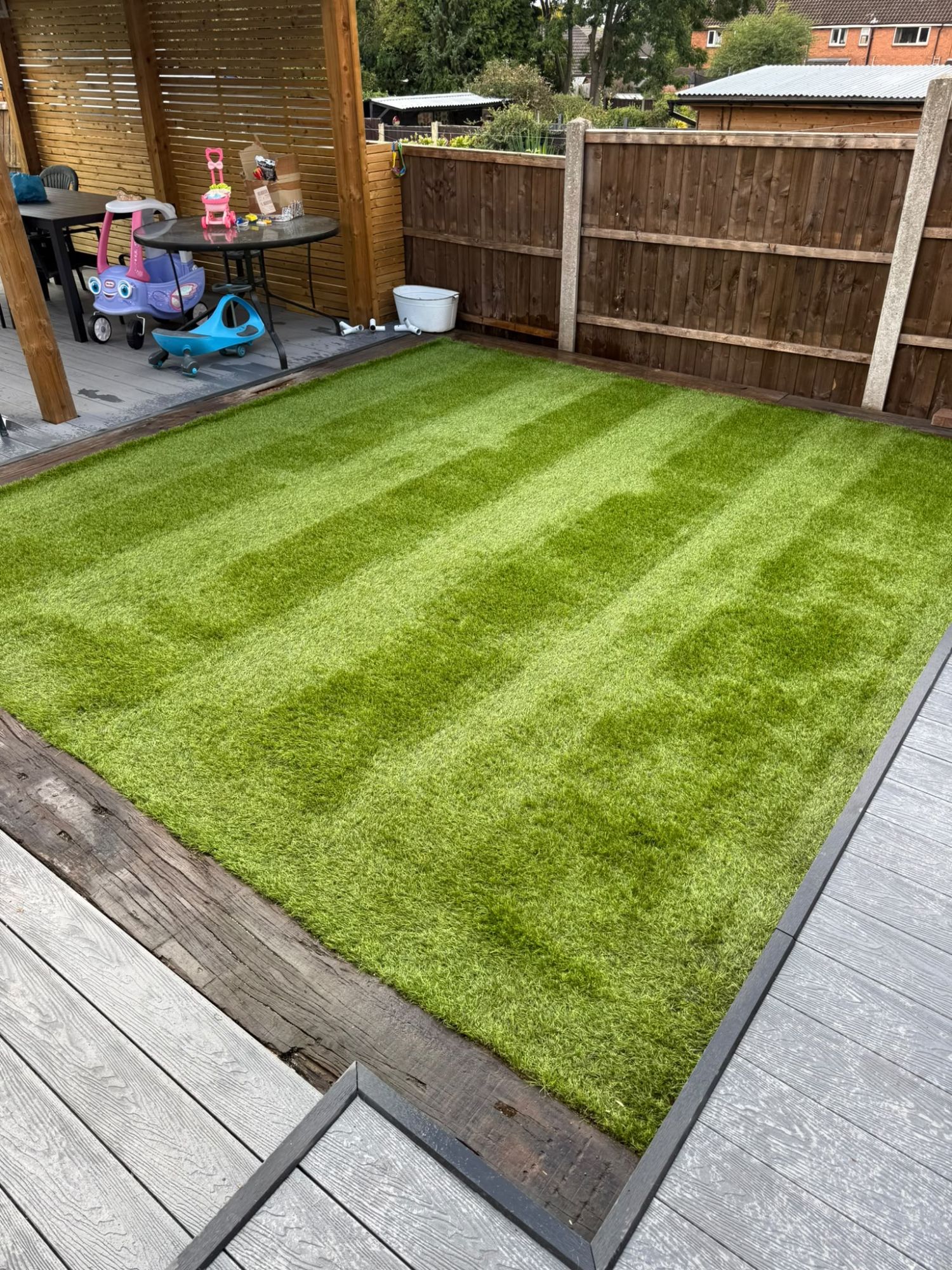 Freshly cleaned artificial lawn with crisp brushed stripes after a dog and cat urine deep clean