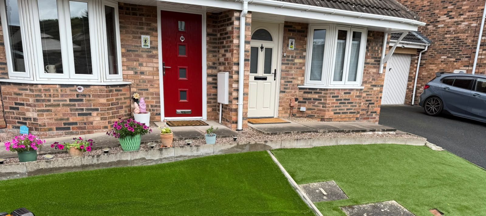 Front artificial lawn part-way through the clean, showing the cleaned section next to the area still to be done