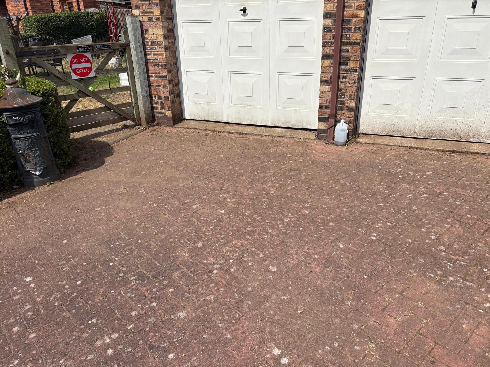The same driveway cleared of weeds and cleaned to a tidy, even finish