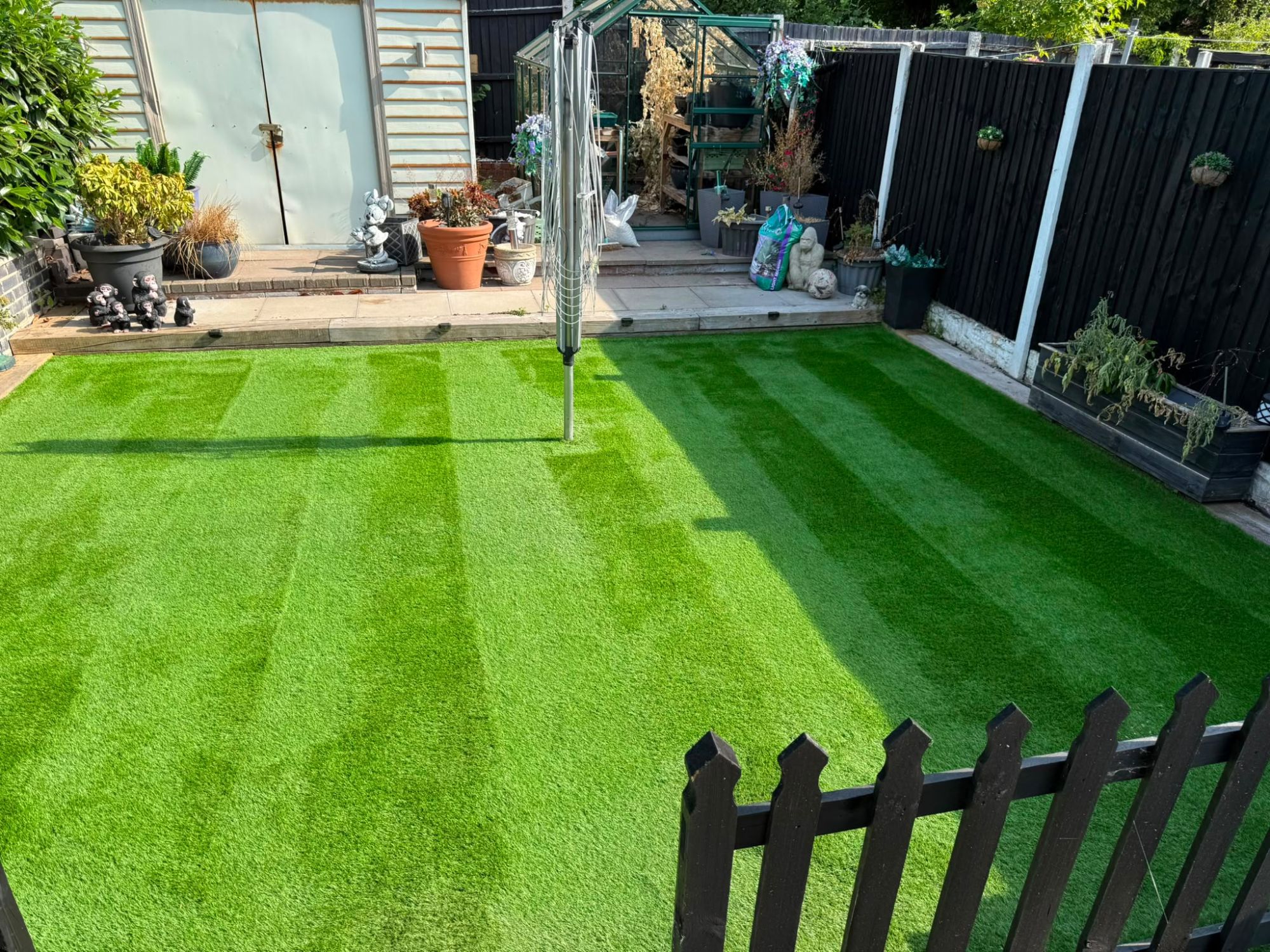 The same artificial lawn leaf-cleared and brushed to a clean, striped finish