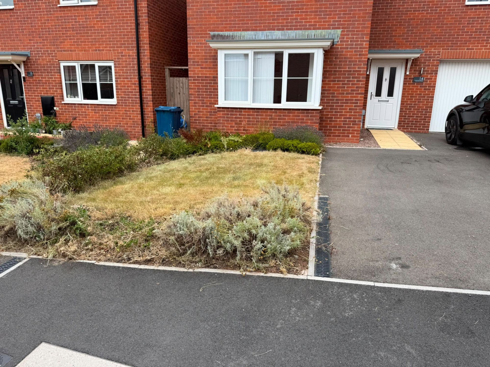 The same front garden cut back and cleared to a tidy, manageable finish
