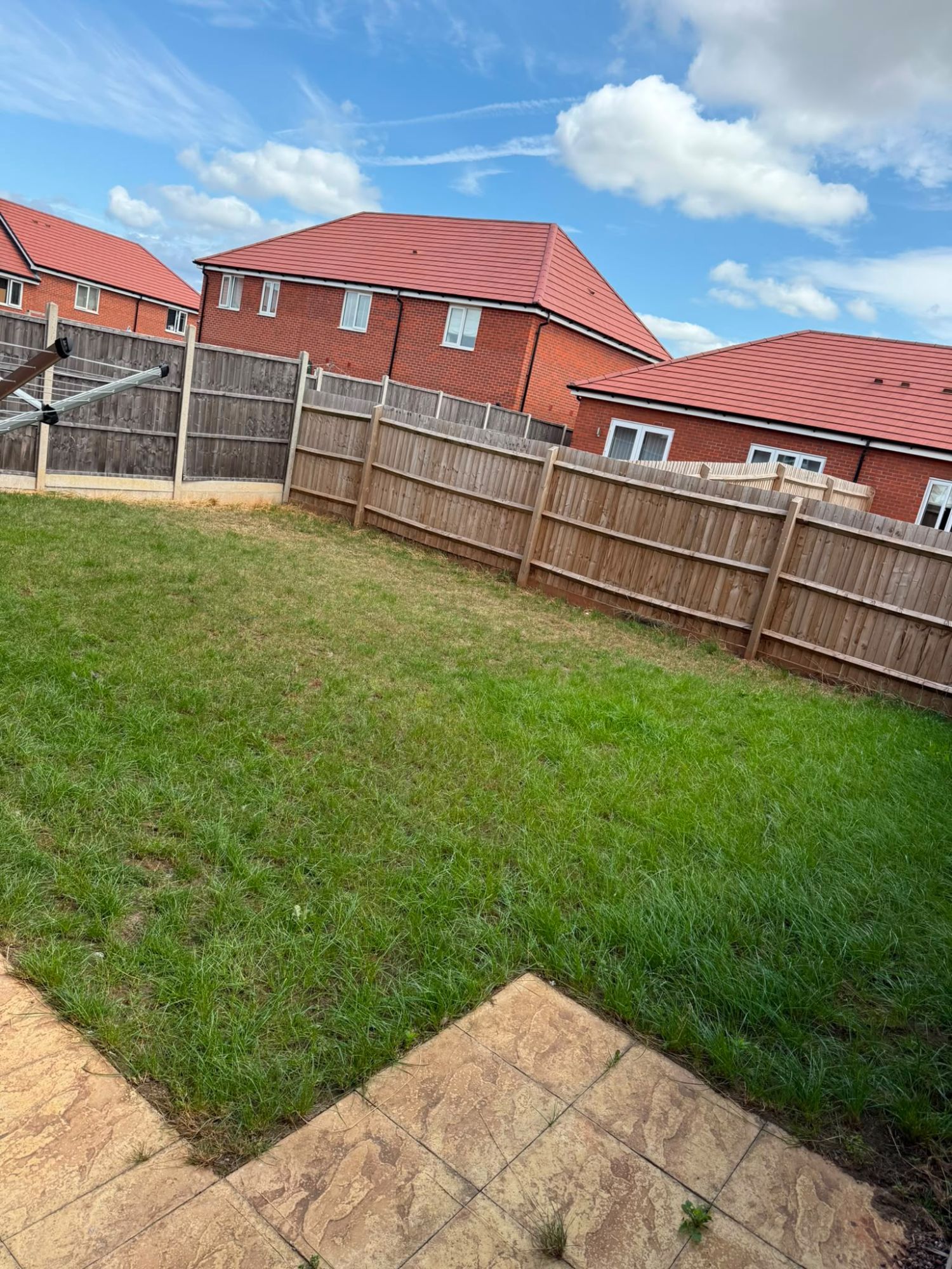 The same lawn cut down and cleared to a neat, usable green finish